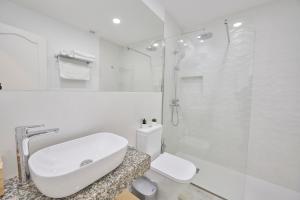 a white bathroom with a sink and a shower at ABLANCAS - La Restinga in La Restinga