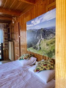 a bedroom with two beds and a painting on the wall at Dom Gościnny U LEONA in Zakopane