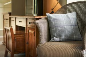 a pillow sitting on a chair next to a desk at Ulbster Arms Hotel near Thurso in Halkirk