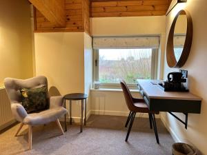 a room with a desk and two chairs and a table at Dorset Resort Hotel in East Stoke