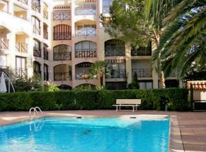 a swimming pool in front of a building at Steddy les coralines in Sainte-Maxime