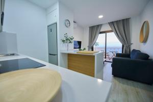 a kitchen and living room with a view of the ocean at ABLANCAS - La Restinga in La Restinga