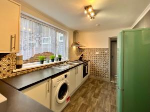 a kitchen with a sink and a dishwasher at Daubney House - Urban Oasis Townhouse in Cleethorpes