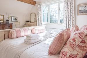 a bedroom with a bed with towels on it at Church Farm House Campsea Ashe in Woodbridge