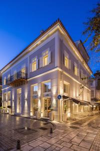 a large white building with lights on at 3 Sixty Hotel & Suites in Nafplio