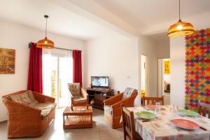 a living room with a table and chairs at LAMINA Appart in Antananarivo