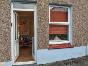 an open door of a house with a living room at The Little House in Conwy