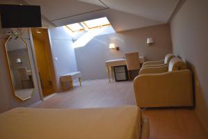 a hospital room with a bed and a mirror at Hotel Rezidenca Desaret in Berat