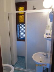 a bathroom with a shower and a toilet and a sink at Sabah Pension in Antalya