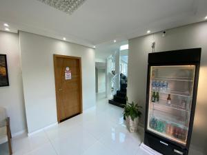 an empty hallway with a refrigerator in a building at Hotel C&A in Bofete