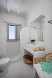 a white bathroom with a sink and a toilet at Blue Sea Villa in Serifos Chora