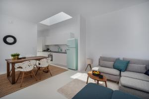 a living room with a couch and a table at Blue Sea Villa in Serifos Chora +79 photos
