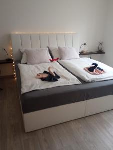 two people are laying on a bed withskirts at Academic Apartment Brno (AAB) 2+1 (62 m²) in Brno