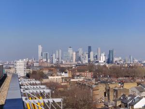 a view of a city from a balcony with chairs at Luxury One Bedroom Flat in Deptford in London