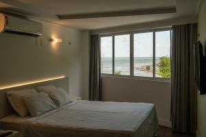 Ένα ή περισσότερα κρεβάτια σε δωμάτιο στο Flat Studio Beira Mar Cabo Branco