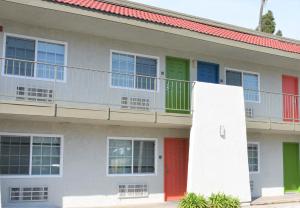 a building with colorful doors and a balcony at Signature Anaheim Maingate in Anaheim