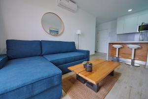 a living room with a blue couch and a table at ABLANCAS - La Restinga in La Restinga