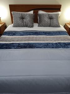 a large bed with two pillows on top of it at Porto Cruz in Vila Nova de Gaia