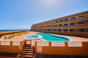 a hotel with a swimming pool next to the ocean at ABLANCAS - La Restinga in La Restinga