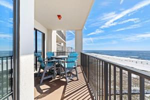 a balcony with a table and chairs and the ocean at Phoenix VII 1102 in Orange Beach