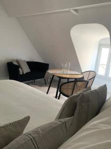 a living room with a couch and a table at appartement catimini in Dijon