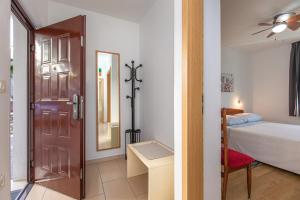 a bedroom with a door and a bed and a mirror at Apartmani Margita in Mošćenička Draga