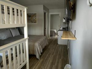 a small bedroom with a bed and a staircase at Shafer Lakeside Resort in Monticello