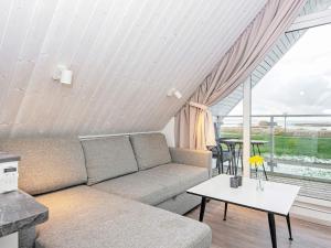 a living room with a couch and a table at Two-Bedroom Holiday home in Wendtorf 6 in Wendtorf