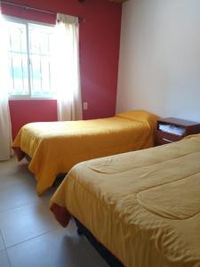 a room with two beds and a window at Dulce Hogar in Maimará