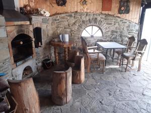 a stone room with a table and a fireplace at Chata u Kapličky - Veleslavice in Větřní