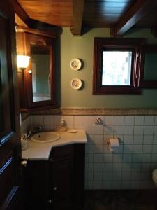 a bathroom with a sink and a mirror and a window at Melina's Mansion in Tsagarada +44 photos