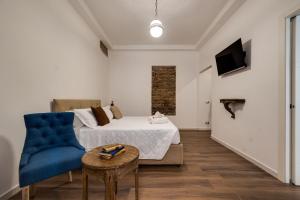 a bedroom with a bed and a couch and a table at CLASSIC FLAT boschetto in Rome