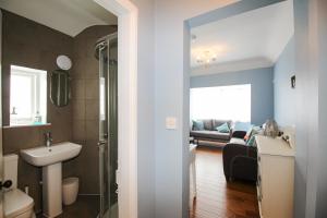 a bathroom with a sink and a toilet and a couch at Seaside House in Weymouth +38 photos