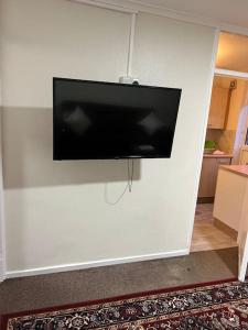 a flat screen tv hanging on a white wall at 016- 1 bedroom church street F31 in London