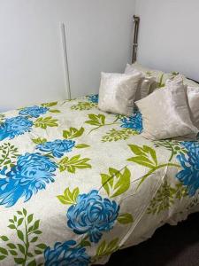 a bed with blue flowers on it with pillows at 016- 1 bedroom church street F31 in London