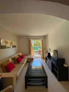 a living room with a couch and a tv at Provencal house, sea side, private parking in Nice