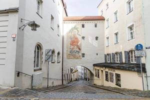 an alley with a mural on the side of a building at Servus Apartments Old Town Premium in Passau