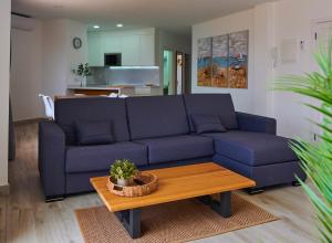 a living room with a blue couch and a table at ABLANCAS - La Restinga in La Restinga