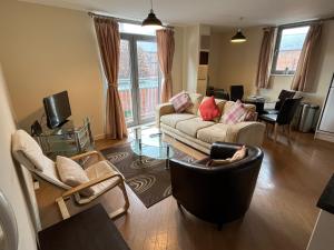 a living room with a couch and a table at Central Darlington Central 2BR Apartment in Darlington