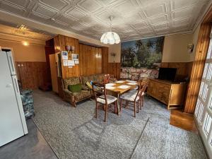 a dining room with a table and chairs at Karolin Apartman in Bükfürdő