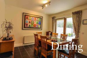 a dining room with a table and chairs at Skelligway Kenmare - Your Luxury Holiday Home in Kenmare