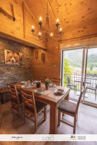 a dining room with a large wooden table and chairs at Les Balcons Montagnards in Ax-les-Thermes