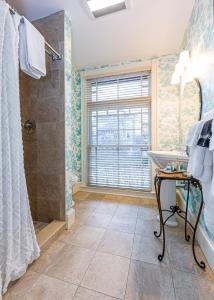 a bathroom with a shower and a sink at Bass Cottage & Ullikana in Bar Harbor