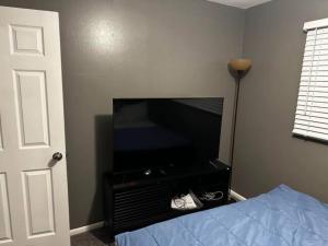 a bedroom with a bed and a flat screen tv at Private Residence - Universal Studio in Orlando