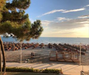 a beach with a bunch of umbrellas and the ocean at Pandora's Seaview Apartment in Durrës