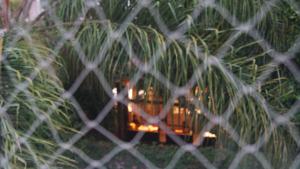 a view of a table through a chain link fence at Departamento en Palermo in Buenos Aires