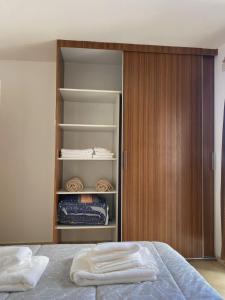 a bedroom with a bed and a wooden closet at SANTA ROSA in Cordoba