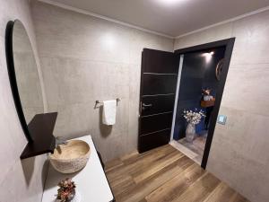 a bathroom with a sink and a black door at El Shaddai Casa de Montaña in Lago Puelo +71 photos