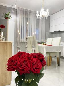 a large bouquet of red roses in a kitchen at Albina apartman in Eger