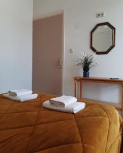 a bedroom with a bed with towels on it at DREAM & HARMONY in Artemida